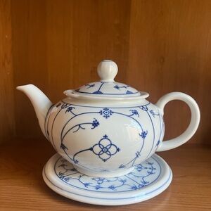 Vintage Charming Blue and White Teapot with a stand. It has a tiny chip.